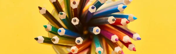 Panoramic shot of sharpened and bright color pencils isolated on yellow — Stock Photo