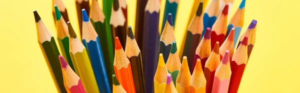 Panoramic shot of sharpened end bright color pencils isolated on yellow — Stock Photo