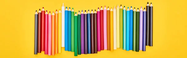 Panoramic shot of color pencils set isolated on yellow — Stock Photo