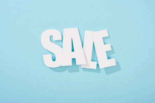 Top view of white sale lettering on blue background — Stock Photo