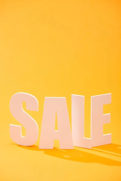 White sale lettering on bright orange background — Stock Photo