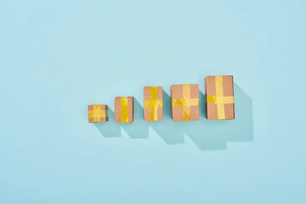 Top view of closed cardboard boxes on blue background with copy space — Stock Photo