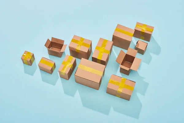 Top view of cardboard boxes on blue background with copy space — Stock Photo