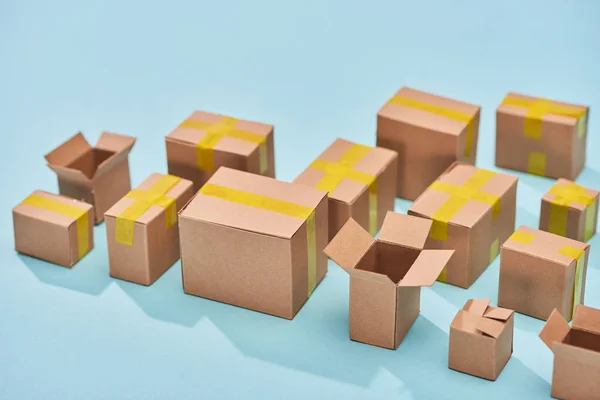 Postal cardboard boxes on blue background with copy space — Stock Photo