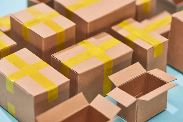 Close up view of cardboard postal boxes on blue background — Stock Photo