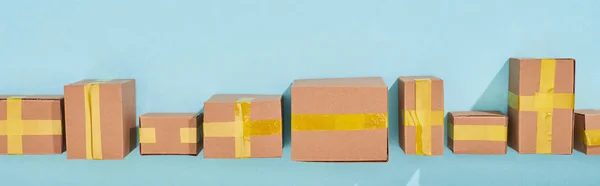 Panoramic shot of miniature postal boxes on blue background — Stock Photo