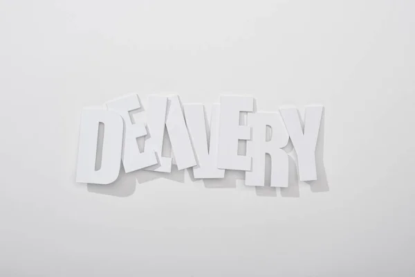 Crooked delivery inscription with shadow on white background — Stock Photo