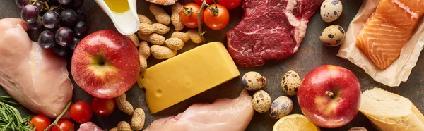 Panoramic shot of raw meat, poultry and fish with cheese, peanuts, fruits and vegetable — Stock Photo