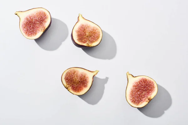 Top view of ripe cut delicious figs on white background — Stock Photo