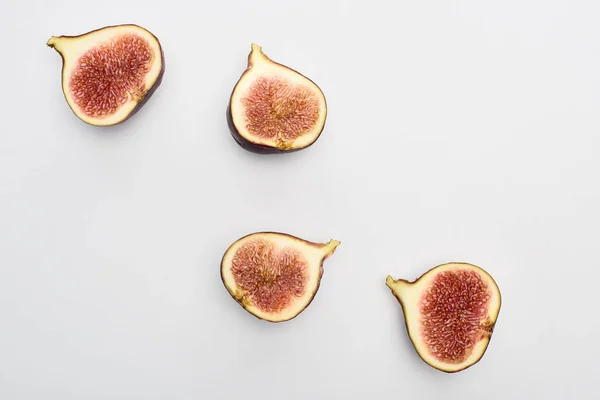 Top view of ripe cut tasty figs on white background — Stock Photo