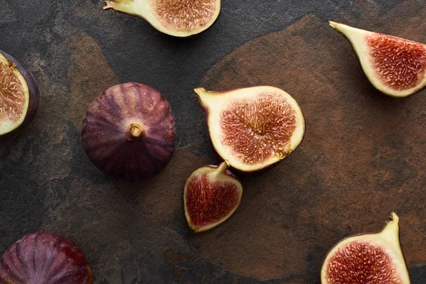 Top view of ripe whole and cut tasty figs on stone background — Stock Photo