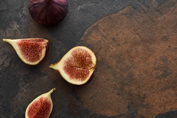 Top view of ripe whole and cut delicious figs on stone background — Stock Photo