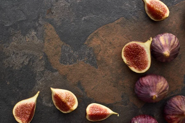 Top view of natural whole and cut delicious figs on stone background — Stock Photo