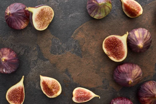 Top view of fresh whole and cut delicious figs on stone background — Stock Photo