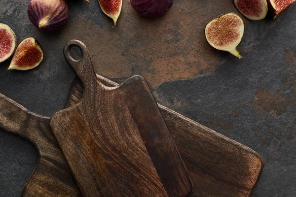Top view of tasty figs and wooden cutting boards on stone background — Stock Photo
