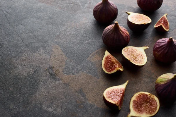 Ripe whole and cut delicious figs on stone background — Stock Photo