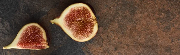 Panoramic shot of ripe cut delicious figs on stone background — Stock Photo