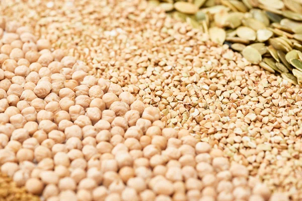 Close up view of dry chickpea, raw buckwheat and pumpkin seeds — Stock Photo