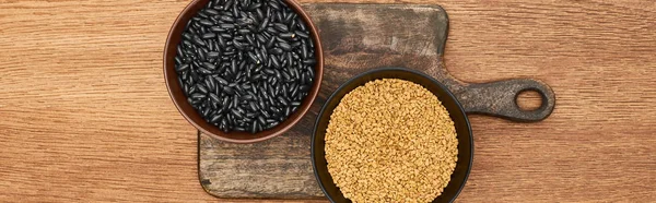 Panoramic shot of bowls with beans ang grains on wooden cutting board — Stock Photo