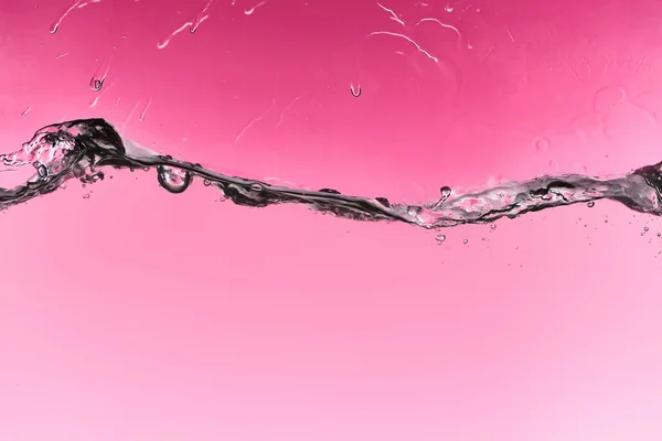 Wavy fresh water on pink background with drops and bubbles — Stock Photo