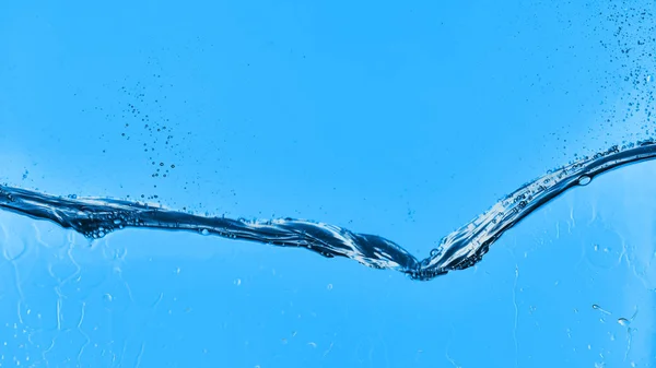 Wavy water on blue background with droplets — Stock Photo