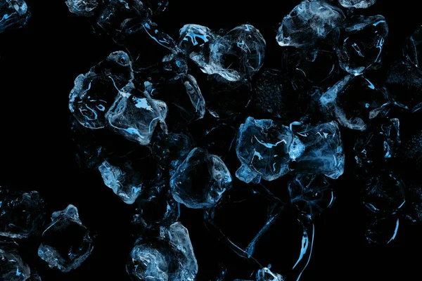 Cubitos congelados de hielo transparente con iluminación azul aislada en negro - foto de stock