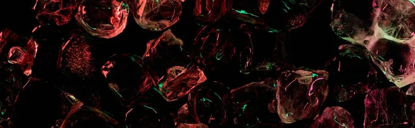 Panoramic shot of clear ice cubes with red and green colorful lighting isolated on black — Stock Photo