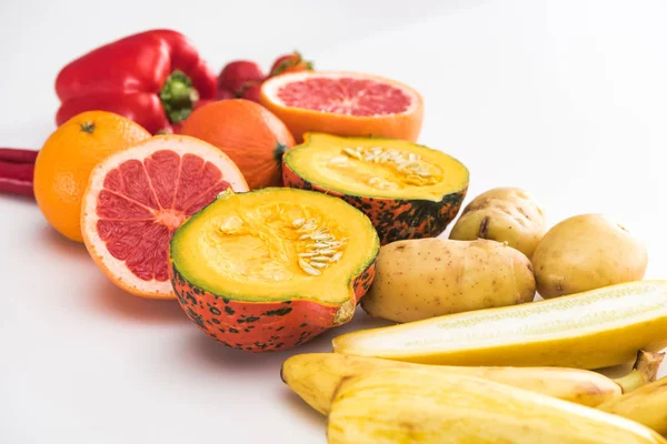 Potatoes, zucchini pumpkin, peppers, orange and grapefruit on white background — Stock Photo
