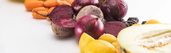 Panoramic shot of red onions, beetroots, carrots and melon on white background — Stock Photo