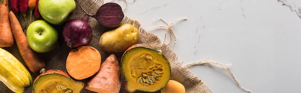 Panoramic shot of autumn vegetables and fruit on marble surface — Stock Photo