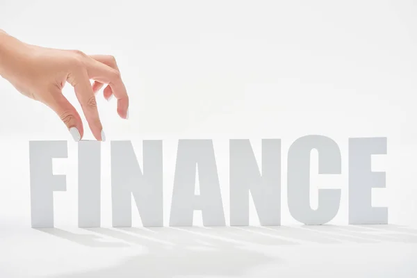 Cropped view of woman holding i letter on finance inscription on white background — Stock Photo