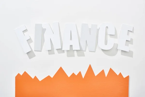 Top view of finance inscription with orange statistic graph on white background — Stock Photo