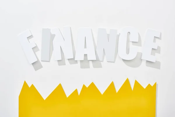 Top view of finance inscription with yellow statistic graph on white background — Stock Photo