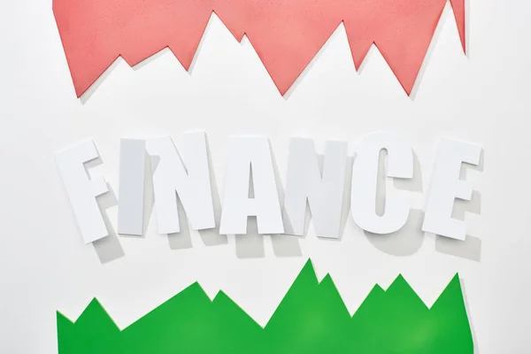 Top view of finance inscription with green and pink statistic graphs on white background — Stock Photo