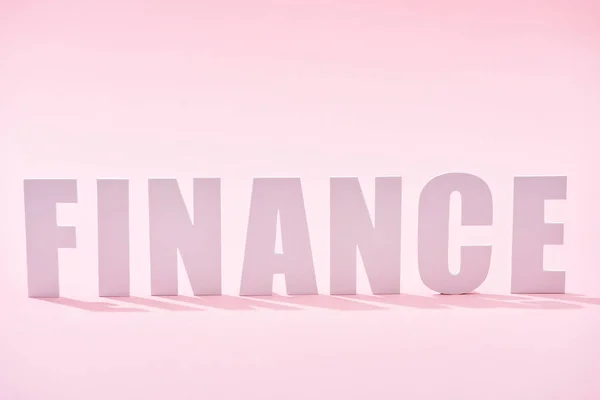 Finance inscription with shadow on pink background — Stock Photo