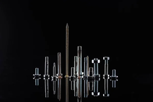 Diverse spotless metallic screws isolated on black — Stock Photo