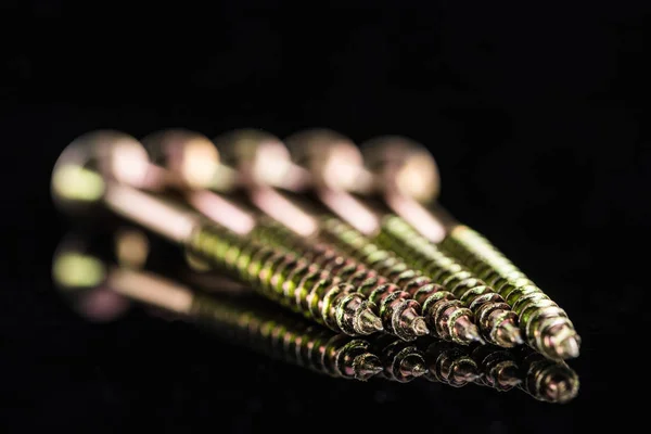 Close up view of metal stud points isolated on black — Stock Photo