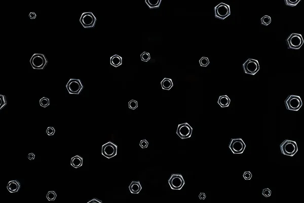 Vista superior del patrón de tuercas metálicas aisladas en negro - foto de stock