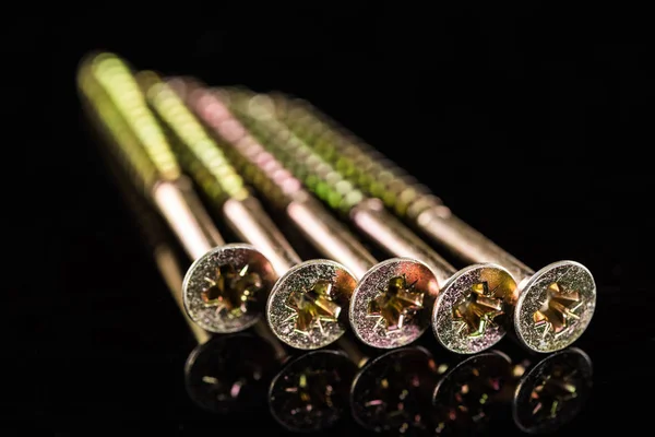 Close up view of metal stud heads isolated on black — Stock Photo