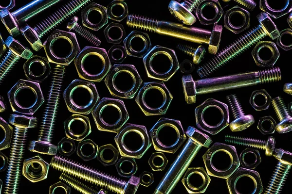 Top view of scattered steel bolts and nuts isolated on black — Stock Photo