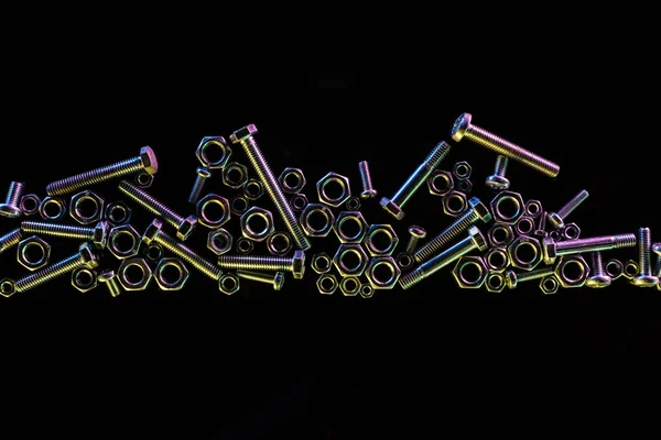 Top view of scattered bolts and nuts set isolated on black — Stock Photo