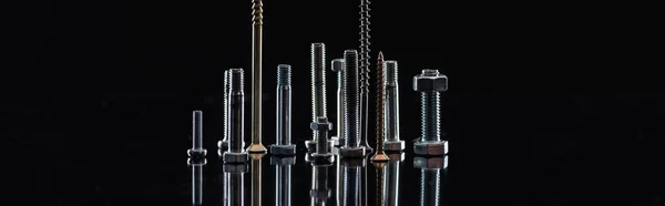 Panoramic shot of various metallic screws isolated on black with copy space — Stock Photo