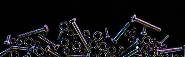 Panoramic shot of scattered steel nuts and bolts isolated on black with copy space — Stock Photo