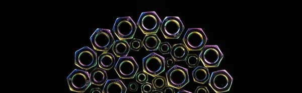 Panoramic shot of semicircle of scattered metal nuts isolated on black — Stock Photo