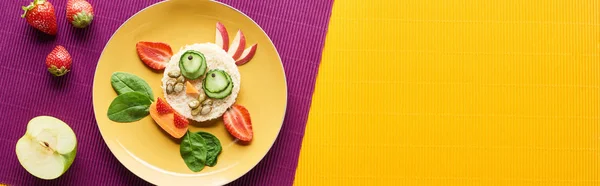 Top view of plate with fancy cow made of food on purple and orange background, panoramic shot — Stock Photo