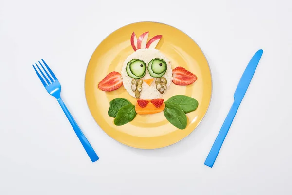 Top view of plate with fancy cow made of food for childrens breakfast near cutlery on white background — Stock Photo