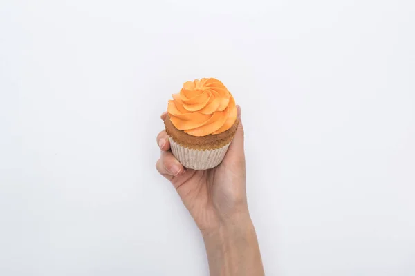 Partial view of woman holding delicious Halloween cupcake isolated on white — Stock Photo