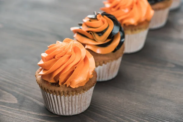 Selective focus of delicious Halloween cupcakes on wooden table — Stock Photo