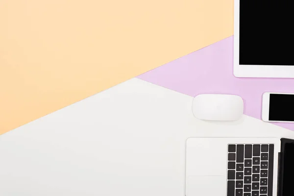 Flat lay with laptop, digital tablet and smartphone with blank screen and computer mouse on beige, violet and white background — Stock Photo