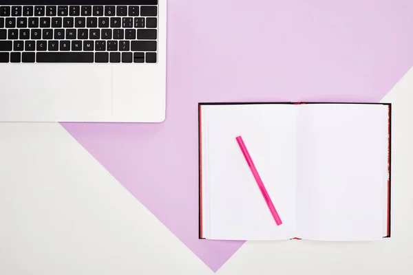 Flat lay with laptop and open blank notebook on violet and white background — Stock Photo